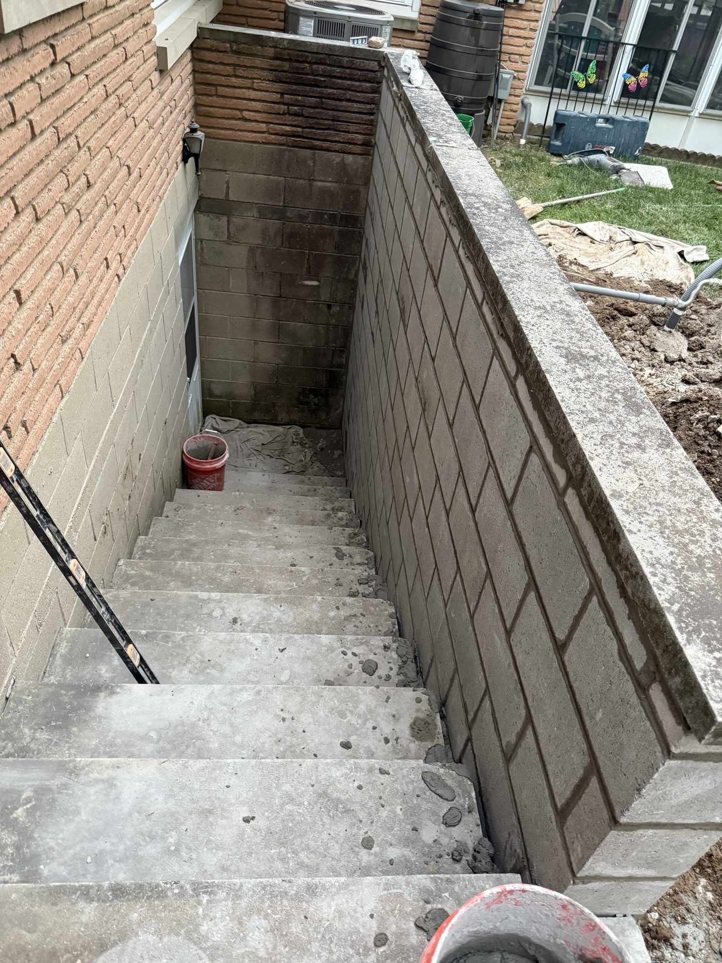 Basement concrete stairs and block retaining wall masonry in Indianapolis, IN