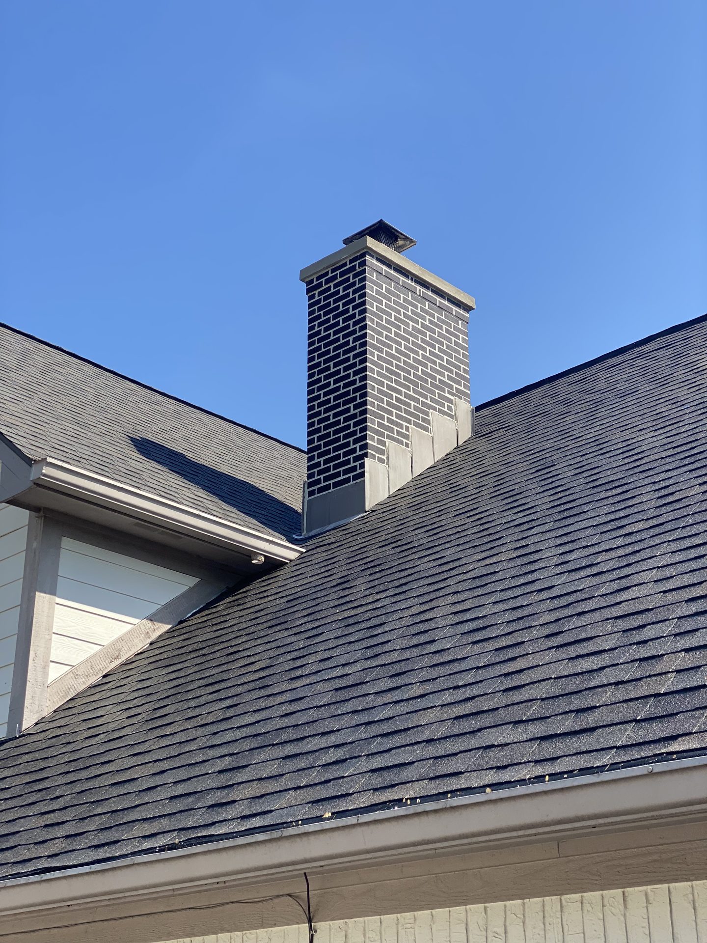 Dark brick chimney construction with flashing by masonry contractor Marion County, Indiana