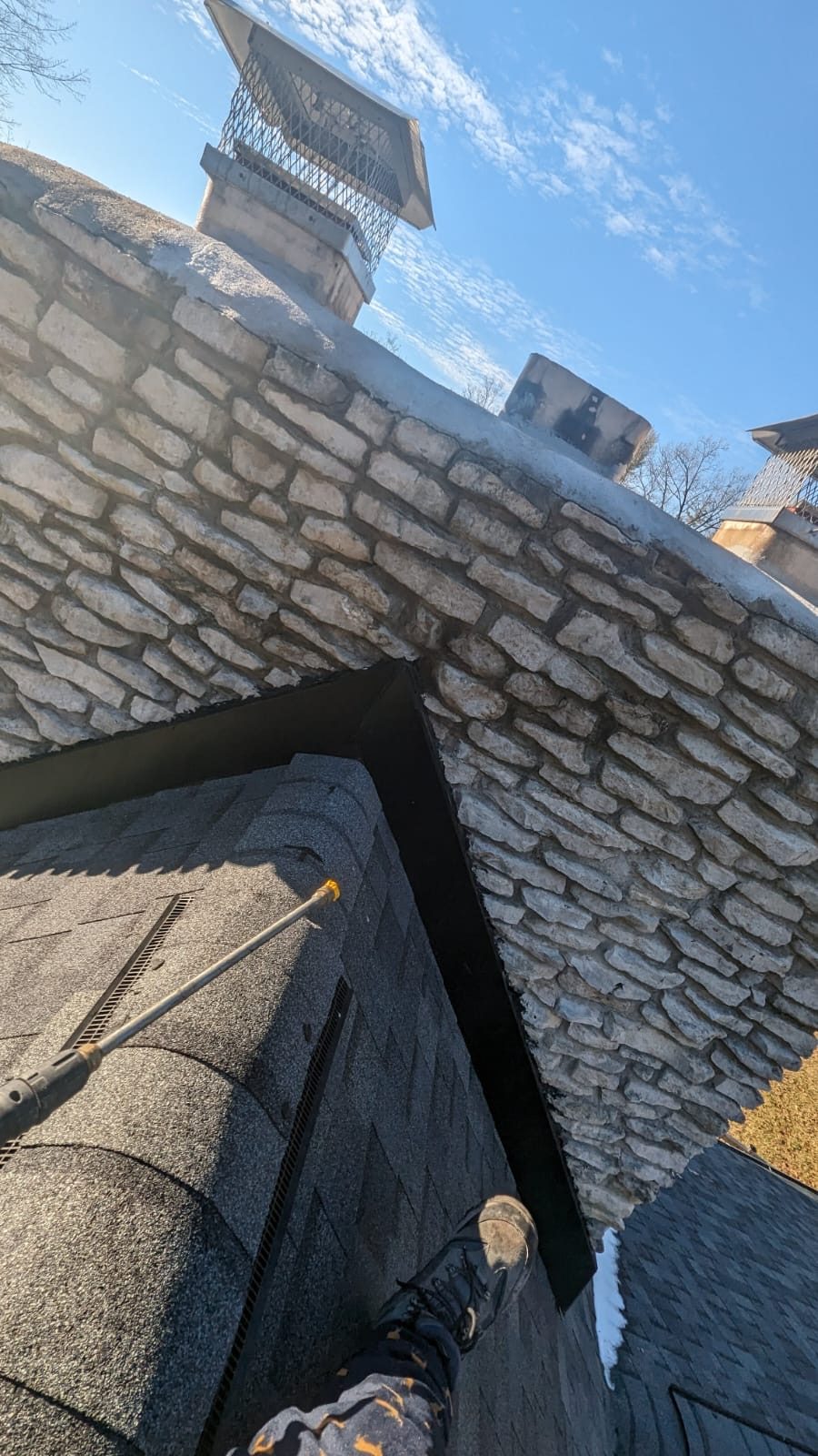 Stone chimney cleaning from the roof serving Indianapolis, IN and Marion County